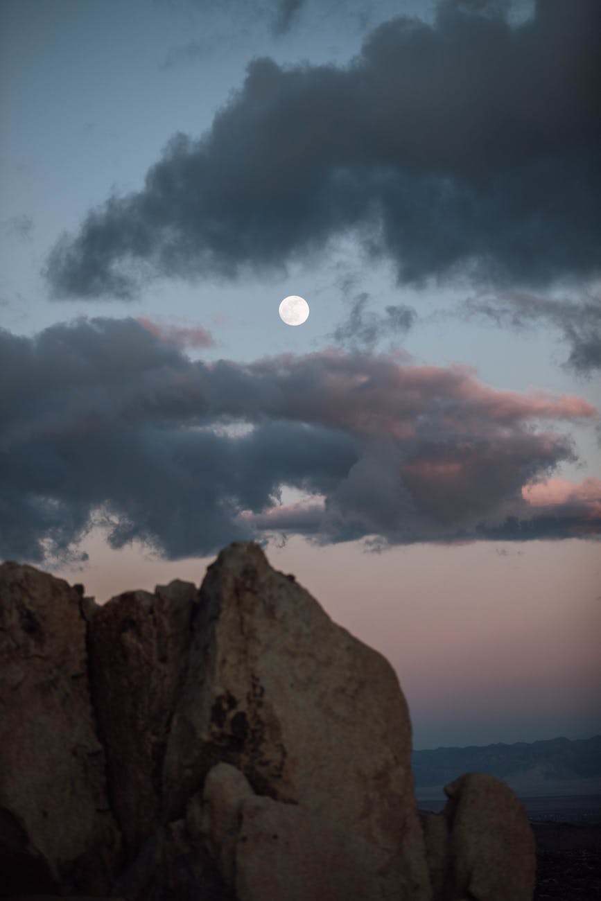photo of full moon on a twilight sky